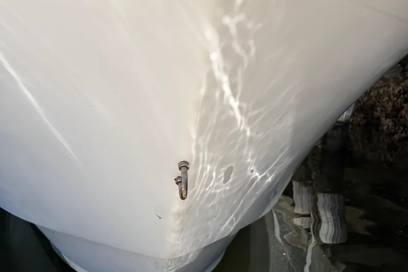 Slide: The Image of Close-up of 2005 Steiger Craft 23 Miami boat hull with water reflections. - 10