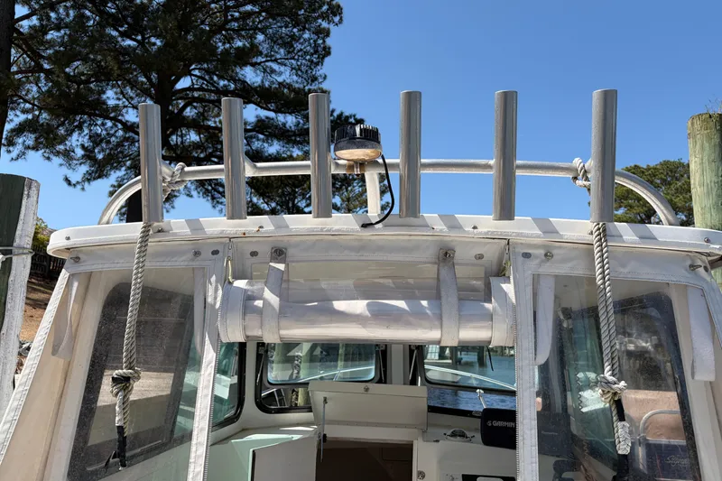 Slide: The Image of 2005 Steiger Craft 23 Miami boat with rod holders and clear skies. - 18