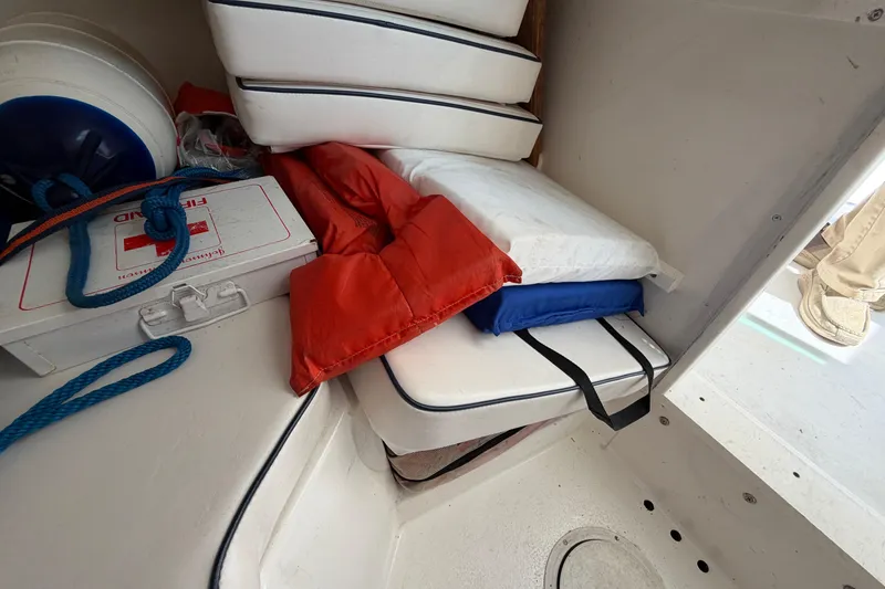 Slide: The Image of Storage area in a 2005 Steiger Craft 23 Miami boat with cushions and safety gear. - 30