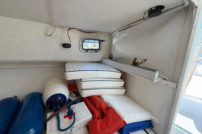 Slide: The Image of Interior of 2005 Steiger Craft 23 Miami boat with cushions and safety equipment. - 31
