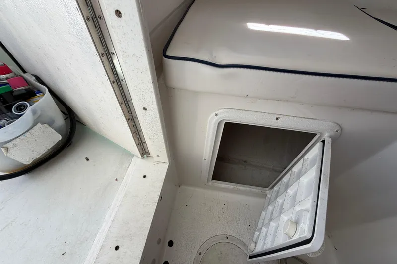 Slide: The Image of 2005 Steiger Craft 23 Miami boat interior with open storage compartment and seat cushion. - 32