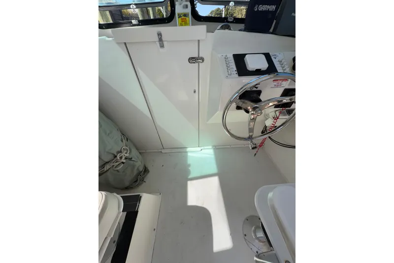 Slide: The Image of 2005 Steiger Craft 23 Miami boat helm with steering wheel and control panel. - 35