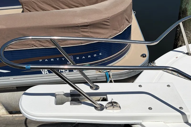 Slide: The Image of Stainless steel bow pulpit with 2005 Steiger Craft 23 Miami boat docked near another vessel. - 7