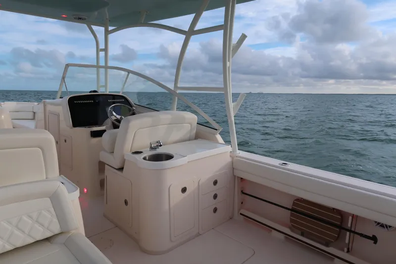 Slide: The Image of 2018 Grady-White Freedom 307 boat interior with ocean view and steering console. - 13