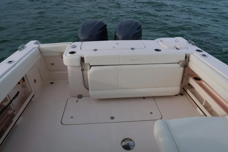 Slide: The Image of 2018 Grady-White Freedom 307 boat deck with dual engines on water. - 15