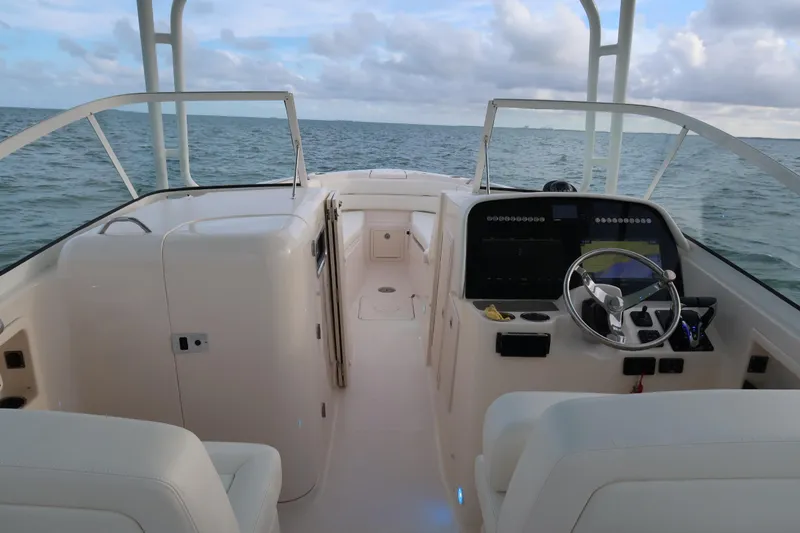 Slide: The Image of 2018 Grady-White Freedom 307 boat interior with ocean view and steering console. - 19