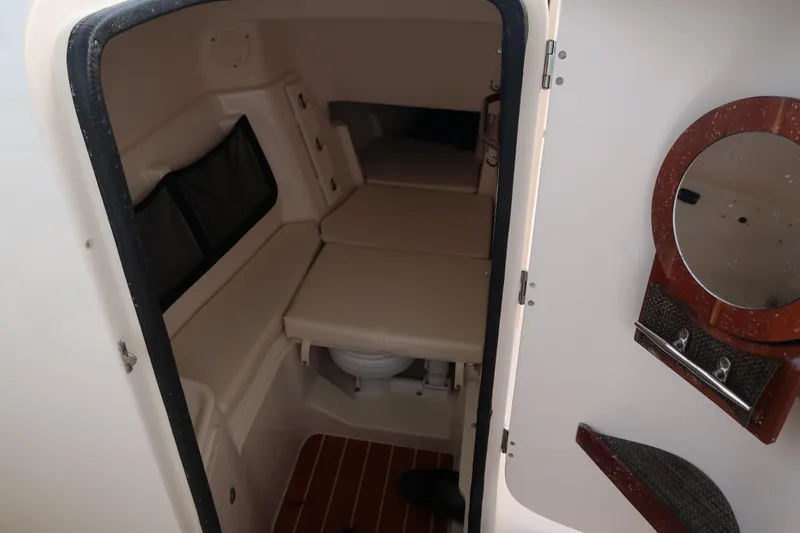 Slide: The Image of 2018 Grady-White Freedom 307 cabin interior with seating and mirror. - 26