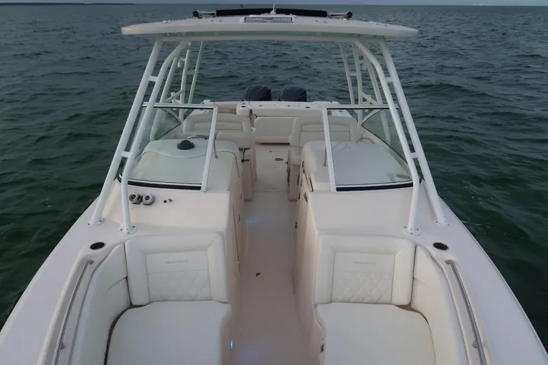 Slide: The Image of 2018 Grady-White Freedom 307 boat on open water, showcasing spacious seating and sleek design. - 27