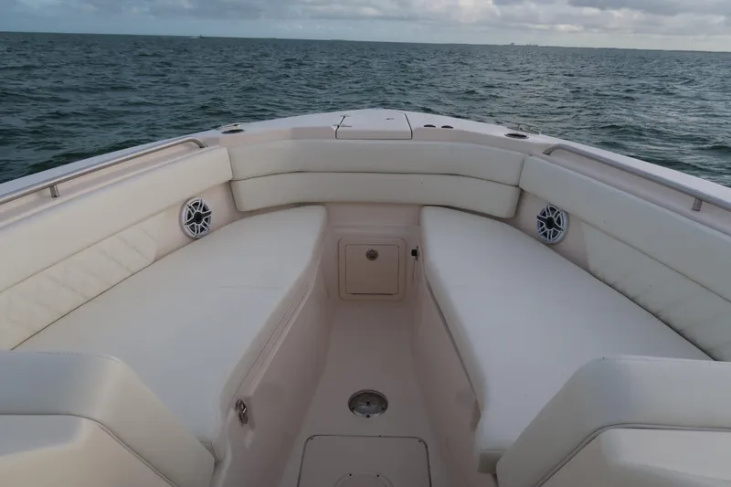 Slide: The Image of 2018 Grady-White Freedom 307 boat interior with cushioned seating on open water. - 28