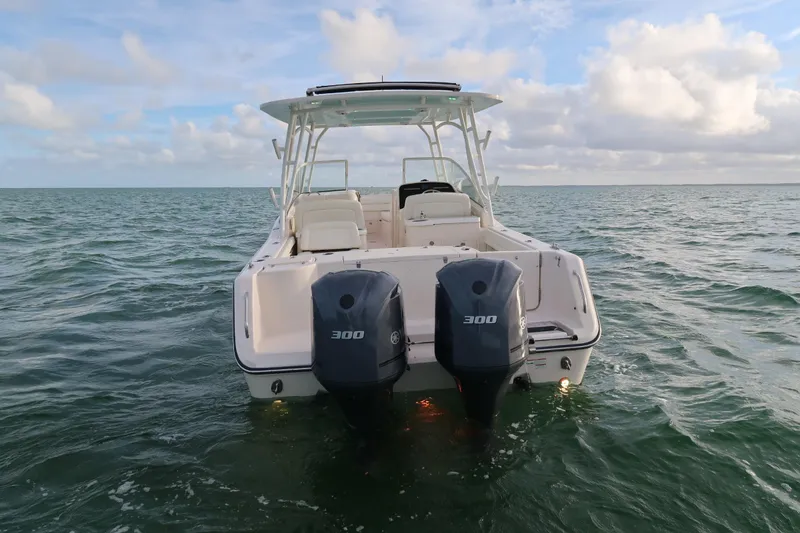 Slide: The Image of 2018 Grady-White Freedom 307 boat with dual 300 horsepower engines on open water. - 3