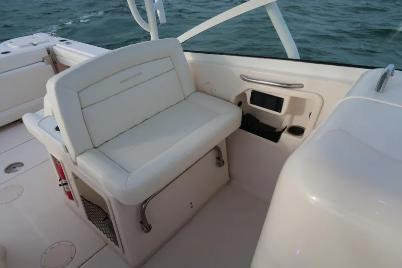 Slide: The Image of 2018 Grady-White Freedom 307 boat interior with seating and control panel. - 31