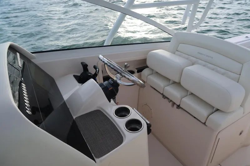 Slide: The Image of 2018 Grady-White Freedom 307 boat interior with steering wheel and seating. - 32