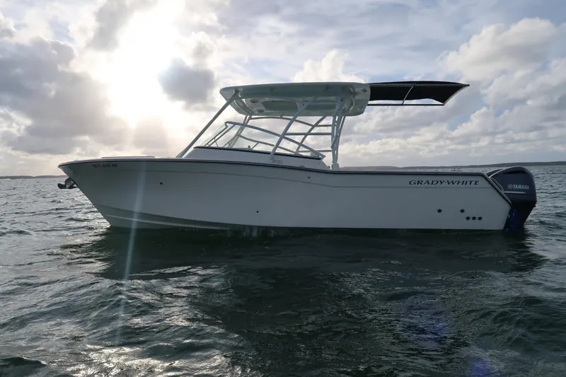 Slide: The Image of 2018 Grady-White Freedom 307 boat on water under cloudy sky. - 34