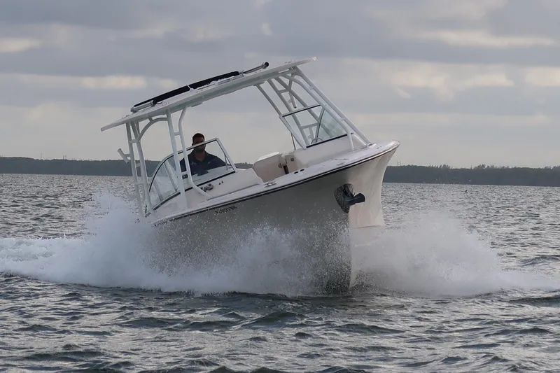 Slide: The Image of 2018 Grady-White Freedom 307 boat navigating through waves on a cloudy day. - 39