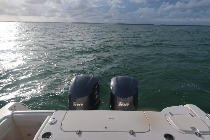 Slide: The Image of 2018 Grady-White Freedom 307 boat with twin Yamaha 300 engines on open water. - 4