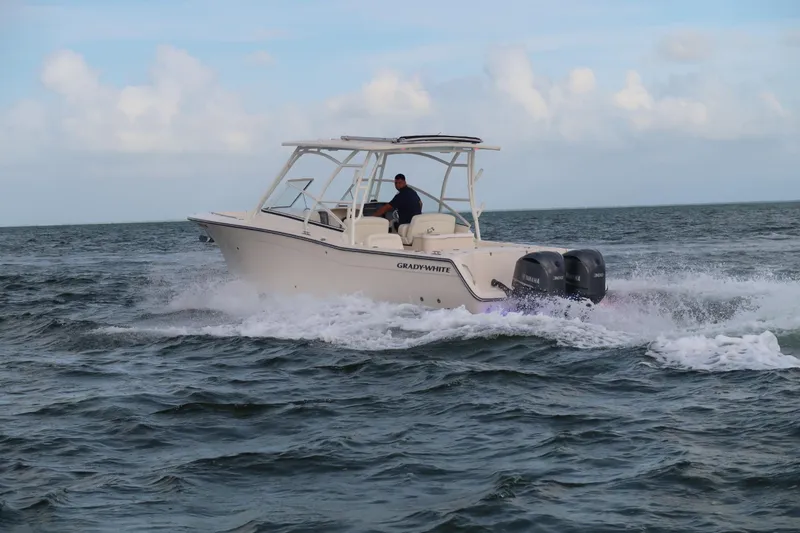 Slide: The Image of 2018 Grady-White Freedom 307 boat cruising on open water with twin engines. - 40