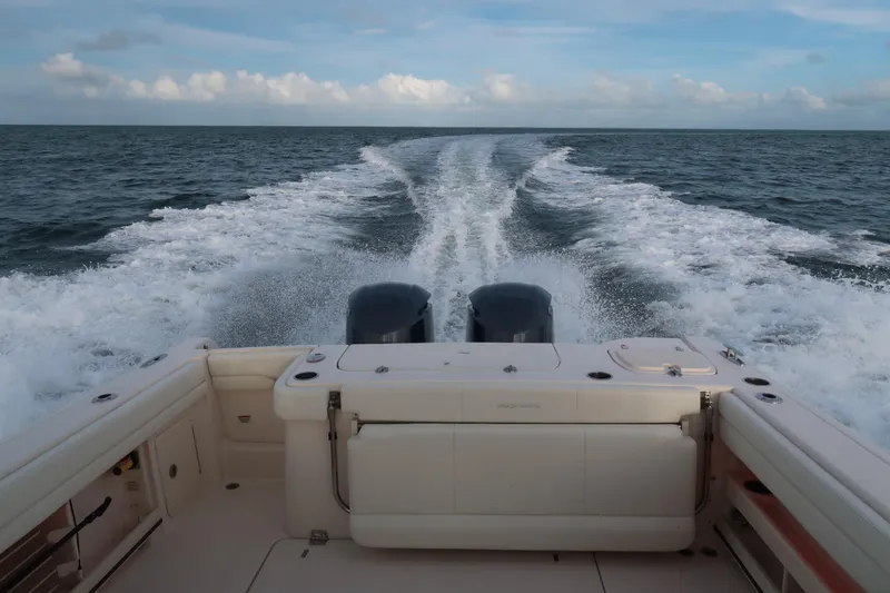 Slide: The Image of 2018 Grady-White Freedom 307 boat cruising on open water, leaving a wake. - 42