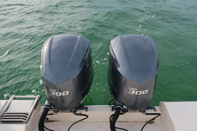 Slide: The Image of Twin Yamaha 300 engines on a 2018 Grady-White Freedom 307 boat in water. - 6