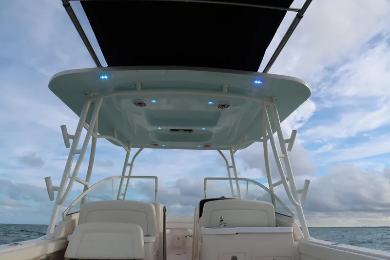 Slide: The Image of 2018 Grady-White Freedom 307 boat interior with canopy, ocean view, and blue LED lights. - 9