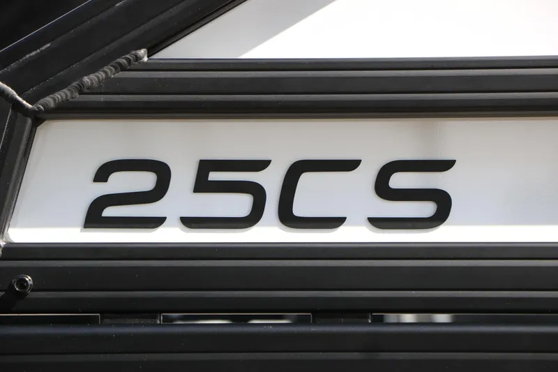Slide: The Image of Close-up of Evotti 725 CS Tri-Toon 2026 model emblem, showcasing '25CS' lettering. - 14