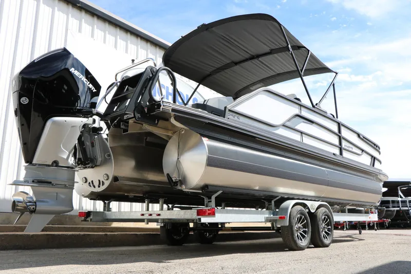 Slide: The Image of 2026 Evotti 725 CS Tri-Toon boat on trailer, featuring sleek design and powerful engine. - 23