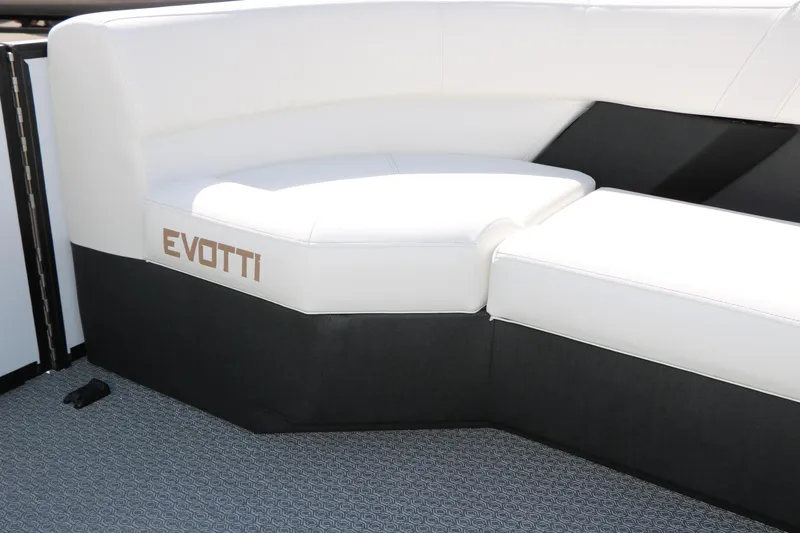 Slide: The Image of Luxurious seating on the 2026 Evotti 725 CS Tri-Toon boat, featuring sleek white and black upholstery. - 34
