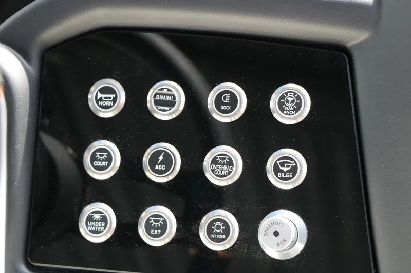 Slide: The Image of Dashboard controls of 2026 Evotti 725 CS Tri-Toon boat, featuring various function buttons. - 54