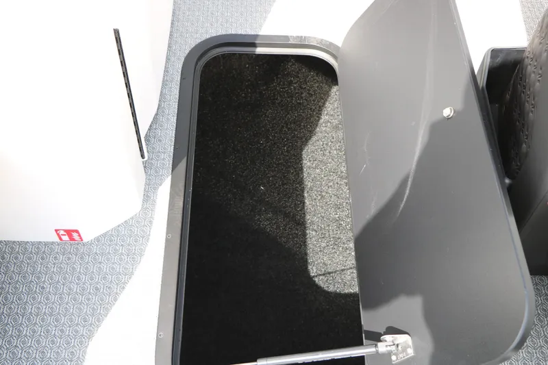 Slide: The Image of Open storage compartment on 2026 Evotti 725 CS Tri-Toon boat with carpeted interior. - 55