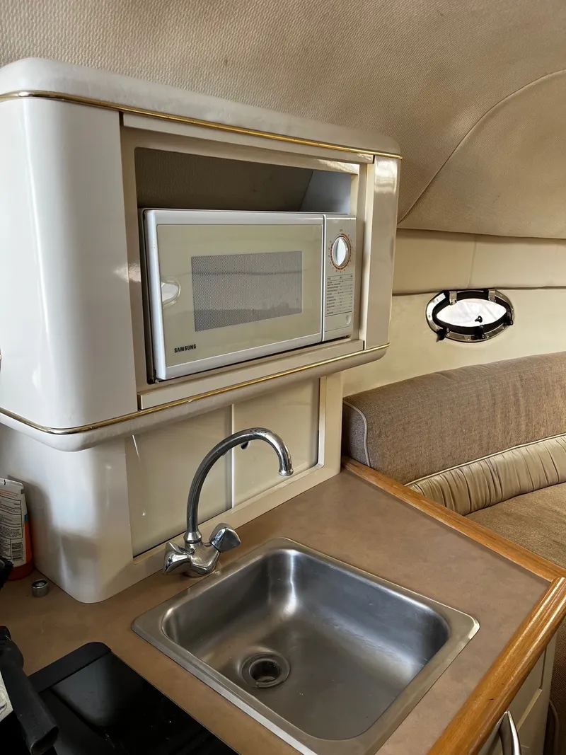 Slide: The Image of Interior of 1998 Maxum 2700 SCR with sink and microwave. - 13