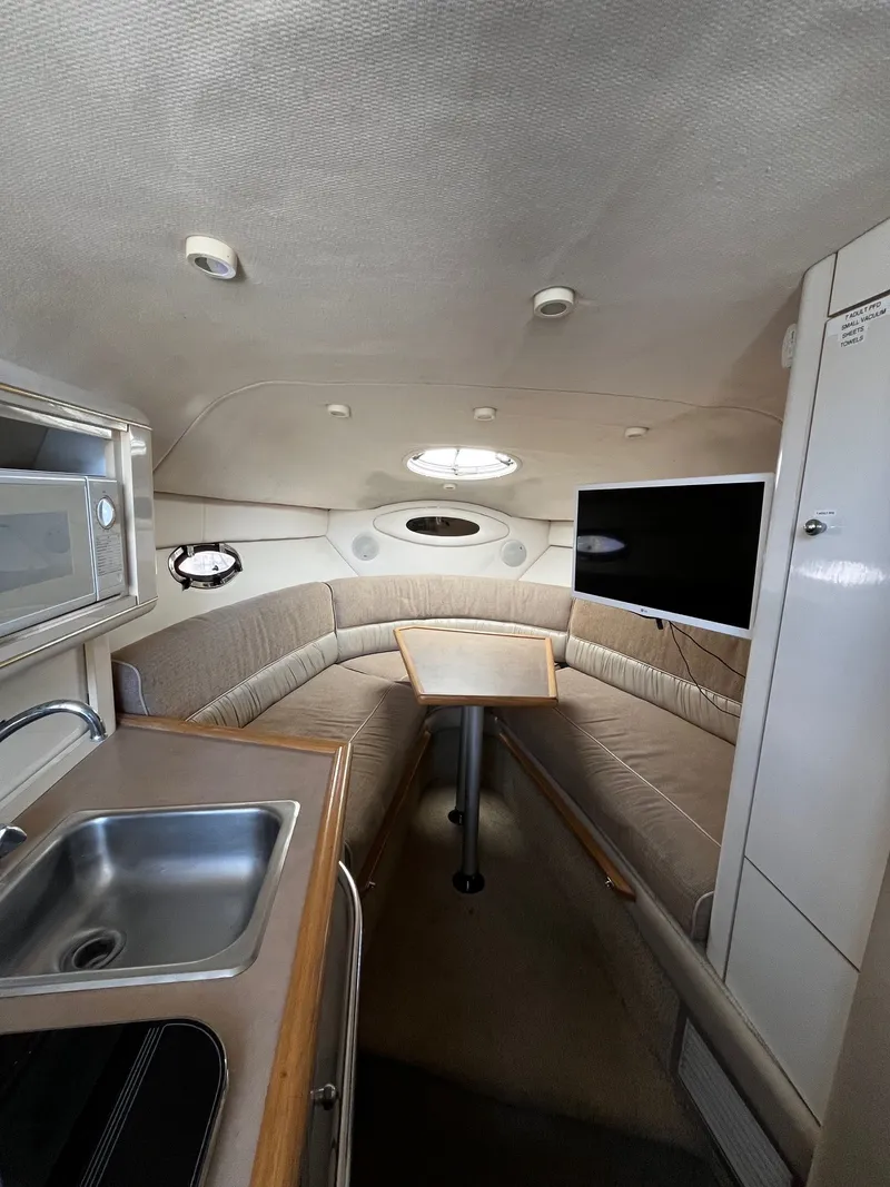 Slide: The Image of Interior of 1998 Maxum 2700 SCR yacht with kitchenette and seating area. - 15