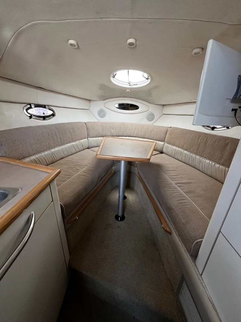 Slide: The Image of Interior of a 1998 Maxum 2700 SCR yacht with seating area. - 17