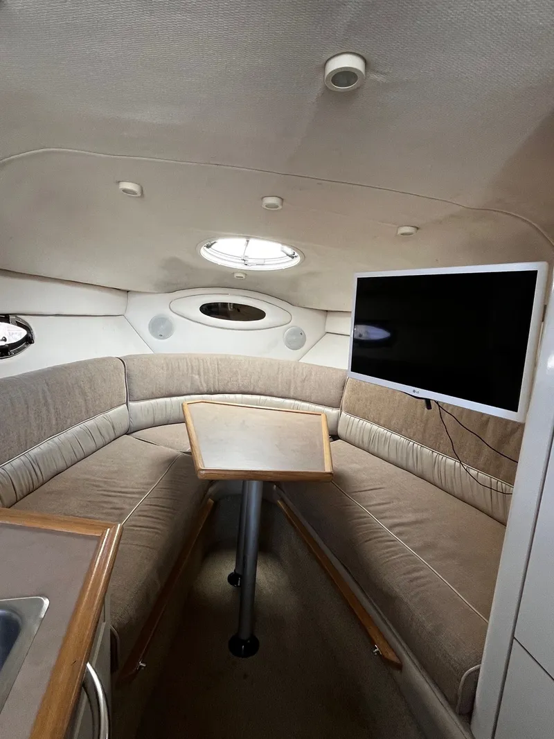 Slide: The Image of Interior of 1998 Maxum 2700 SCR yacht with seating area and TV. - 18