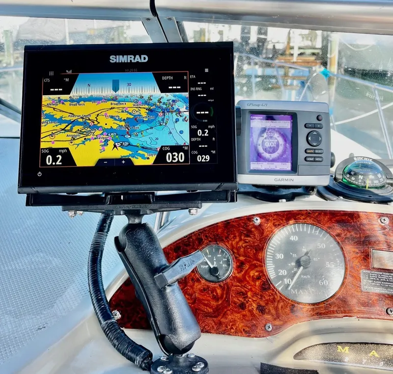 Slide: The Image of Maxum 2700 SCR 1998 boat cockpit with Simrad and Garmin navigation systems. - 8