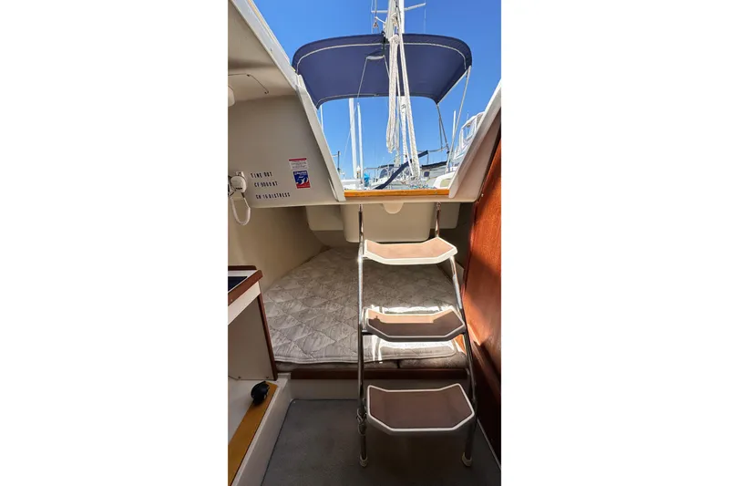 Slide: The Image of Interior of a 2003 Catalina 250 yacht with stairs and sleeping area. - 9