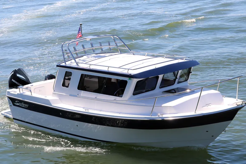 Slide: The Image of 2026 SeaSport Explorer 2400 boat cruising on water with American flag. - 3