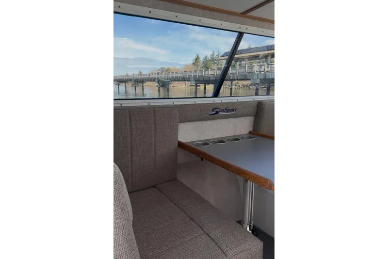 Slide: The Image of Interior of 2026 SeaSport Explorer 2400 boat with window view of a pier. - 6