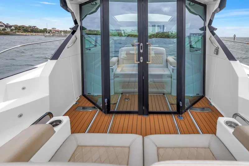 Slide: The Image of 2019 Beneteau Gran Turismo 46 yacht interior with sleek glass doors and luxurious seating. - 10