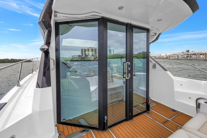 Slide: The Image of 2019 Beneteau Gran Turismo 46 yacht with glass doors and teak deck. - 13