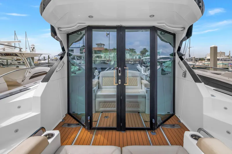 Slide: The Image of 2019 Beneteau Gran Turismo 46 yacht with sleek glass doors and luxurious interior. - 14