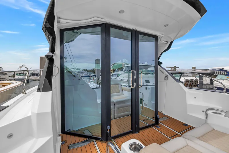 Slide: The Image of 2019 Beneteau Gran Turismo 46 yacht with glass doors and teak deck at marina. - 15