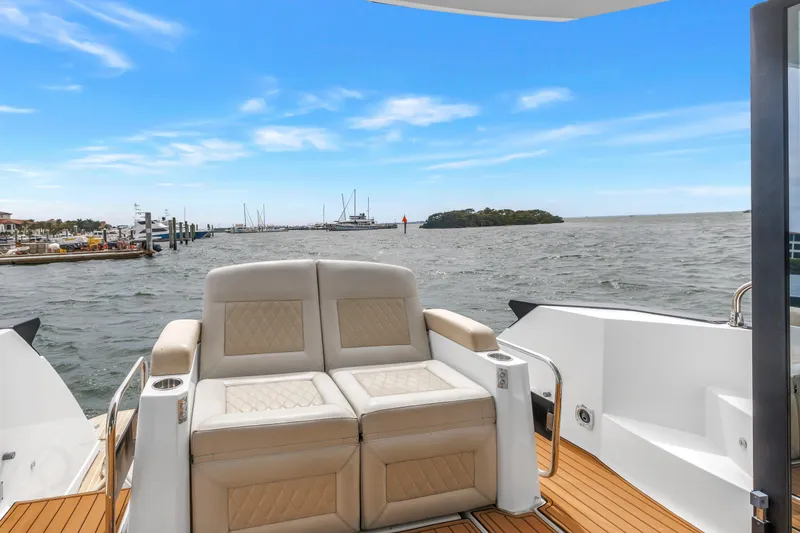 Slide: The Image of 2019 Beneteau Gran Turismo 46 yacht with luxurious seating, ocean view, and clear blue sky. - 18