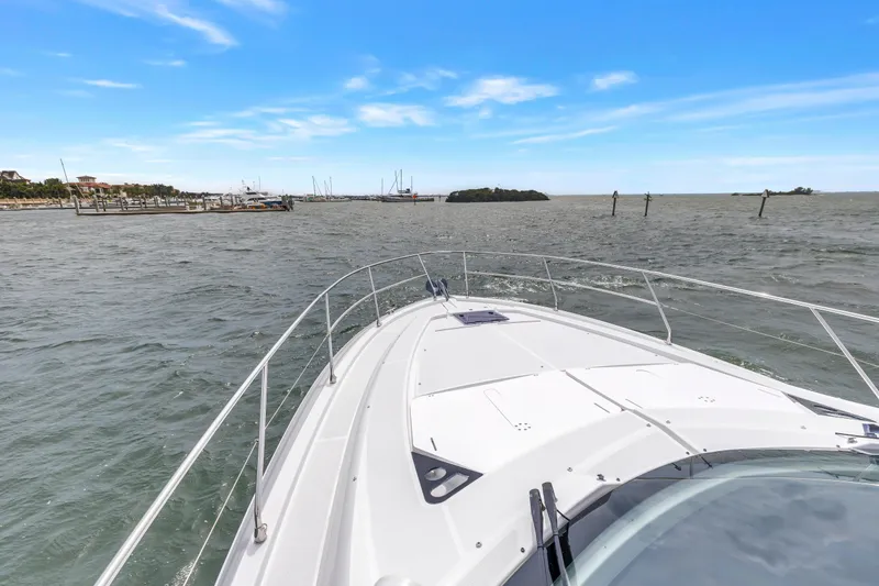 Slide: The Image of 2019 Beneteau Gran Turismo 46 cruising on open water under a clear blue sky. - 19