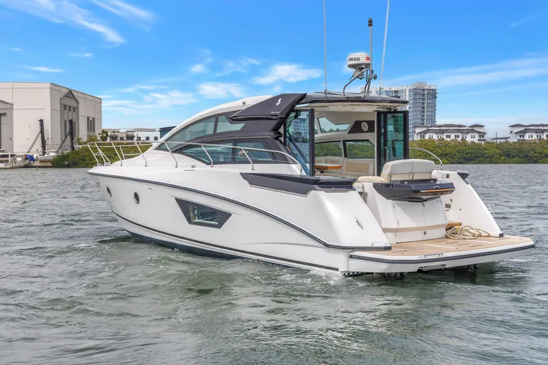 Slide: The Image of 2019 Beneteau Gran Turismo 46 yacht cruising on a calm waterway. - 2
