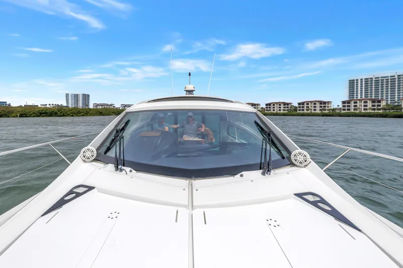 Slide: The Image of 2019 Beneteau Gran Turismo 46 yacht cruising on a scenic waterway with city skyline. - 22