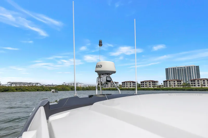 Slide: The Image of 2019 Beneteau Gran Turismo 46 yacht with radar, cityscape background, clear blue sky. - 25