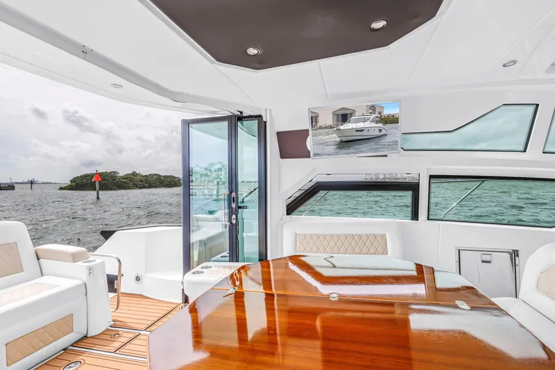 Slide: The Image of Luxurious interior of 2019 Beneteau Gran Turismo 46 yacht with elegant seating and wooden table. - 26