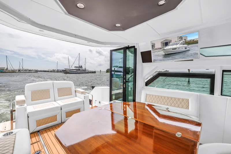 Slide: The Image of Luxurious interior of 2019 Beneteau Gran Turismo 46 yacht with elegant seating and wooden table. - 27