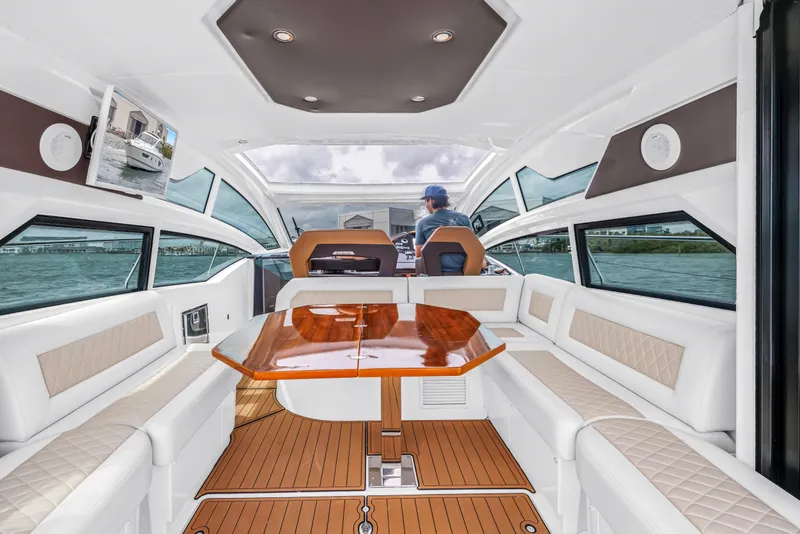 Slide: The Image of Luxurious interior of 2019 Beneteau Gran Turismo 46 yacht with elegant seating and wooden table. - 28