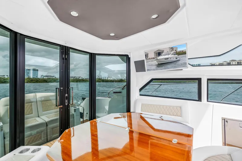 Slide: The Image of Interior of 2019 Beneteau Gran Turismo 46 yacht with elegant seating and panoramic windows. - 29