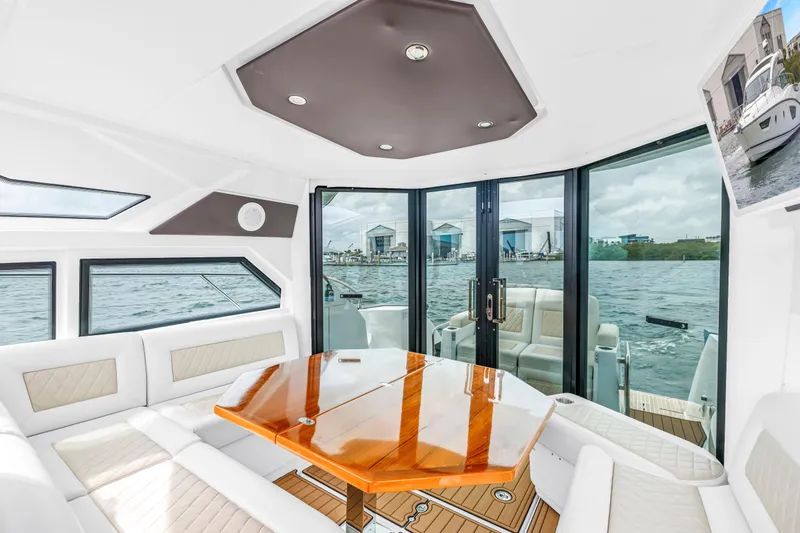Slide: The Image of Luxurious interior of 2019 Beneteau Gran Turismo 46 yacht with elegant seating and waterfront view. - 30